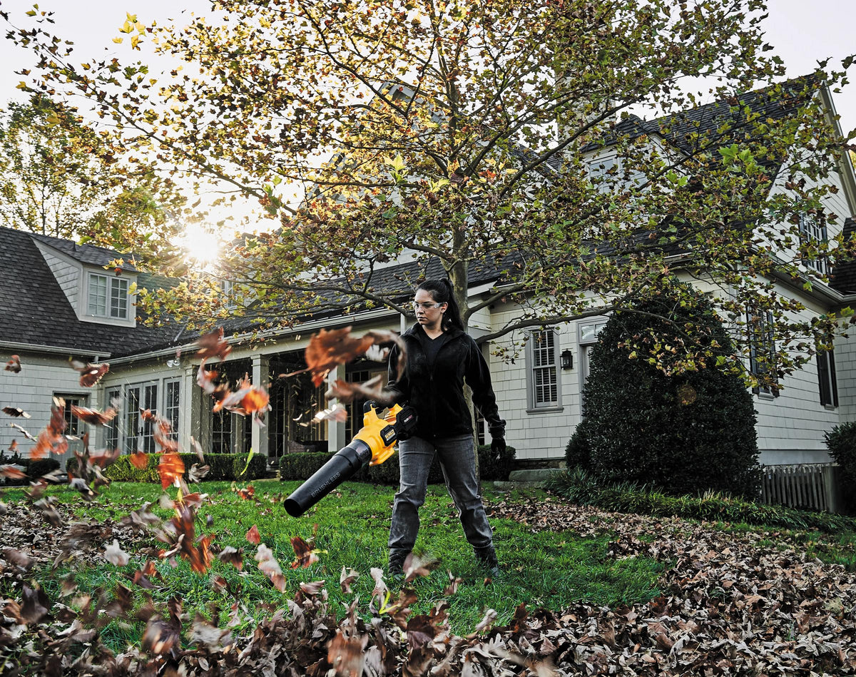 DEWALT cordless leaf blower clearing a yard