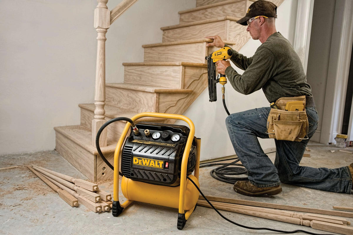 DEWALT air compressor powering a finish nailer on stairs