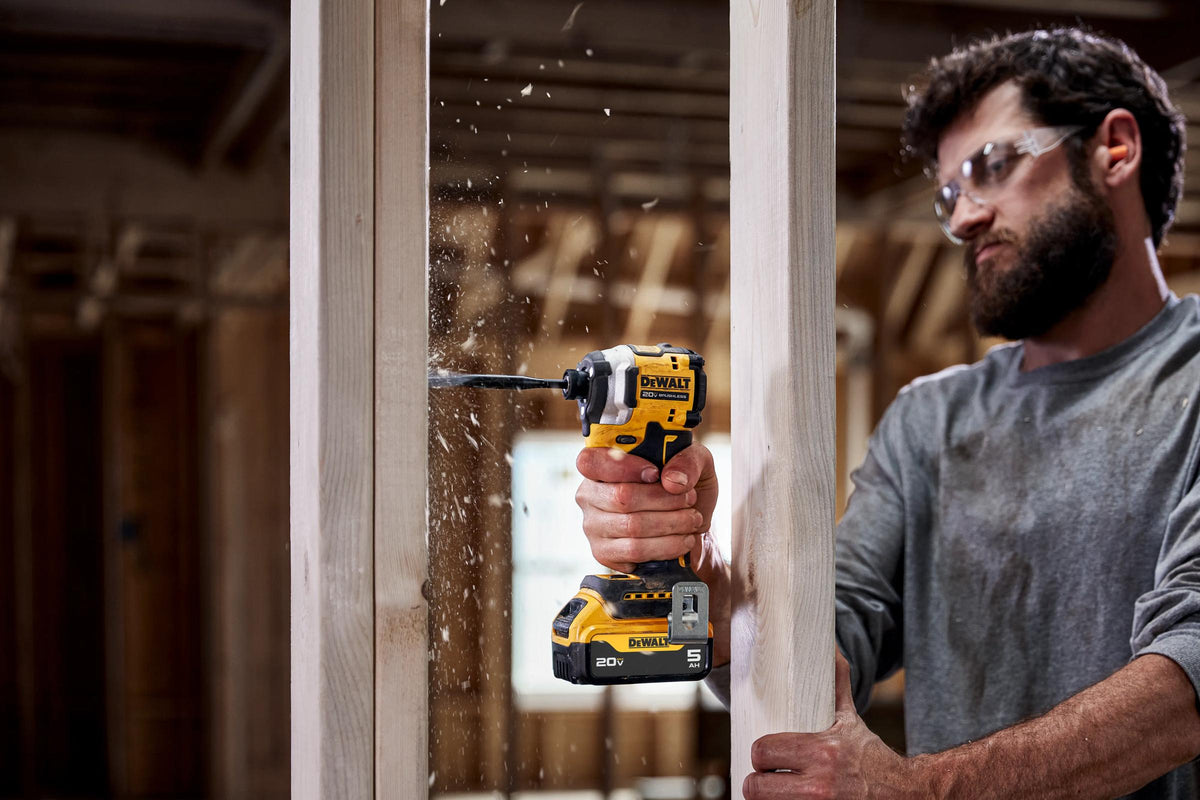 DEWALT impact driver driving screws into framing lumber